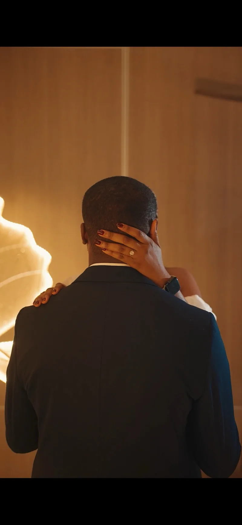Her hand, his shoulder, the ring